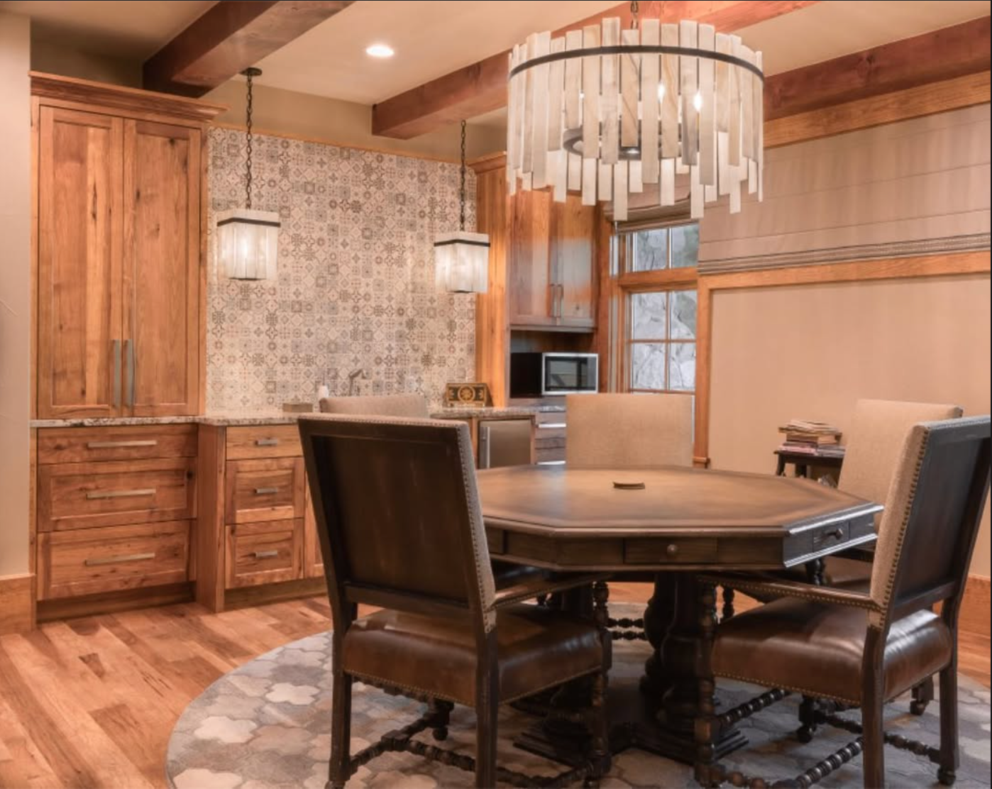 Breakfast room with warm cabinetry and sculptural white chandelier