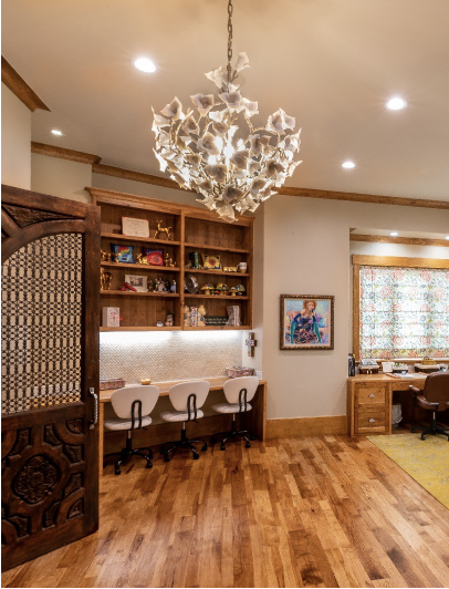 Creative room with carved screen, custom millwork, and sculptural light