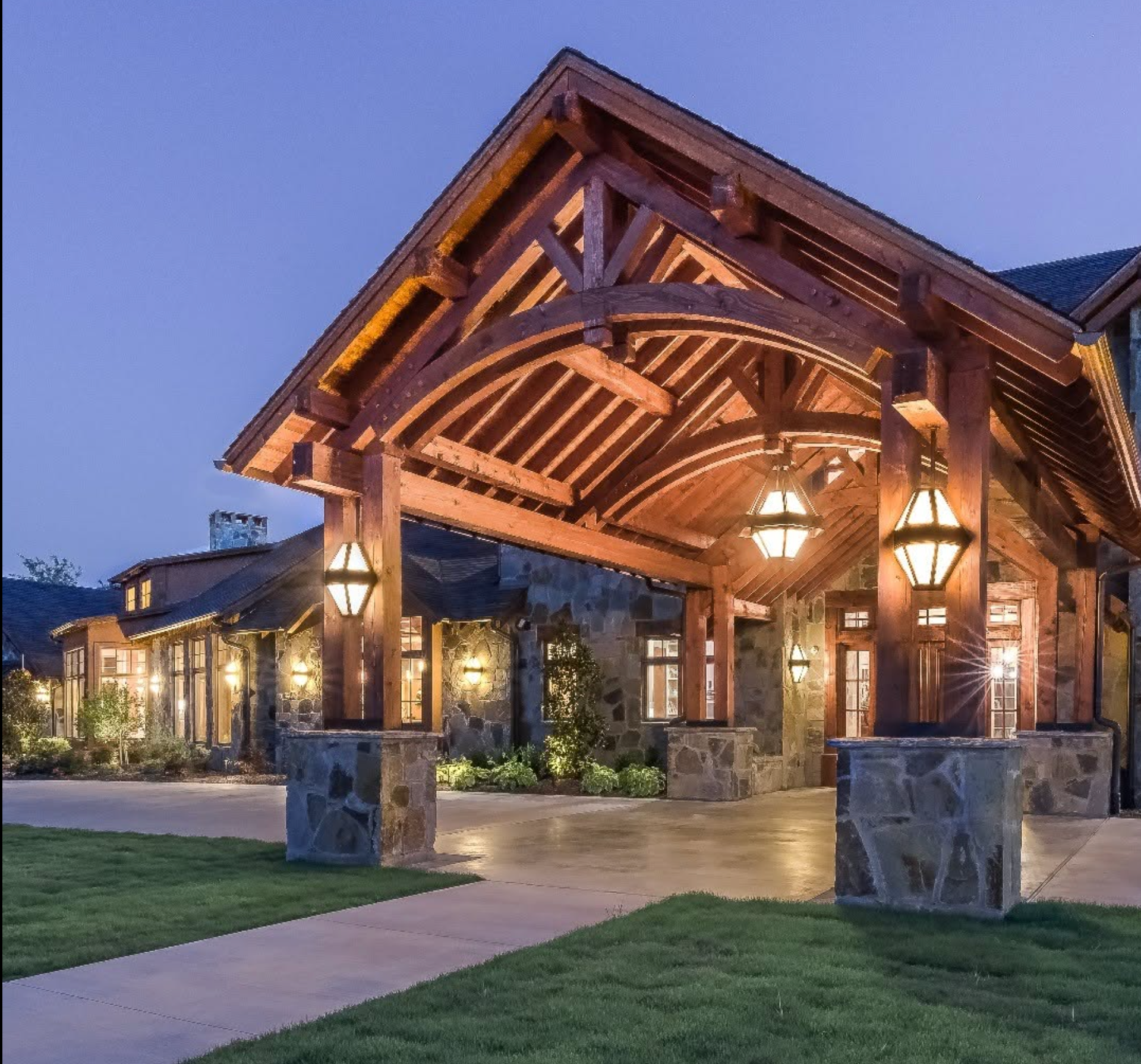 Illuminated timber entry canopy at blue hour
