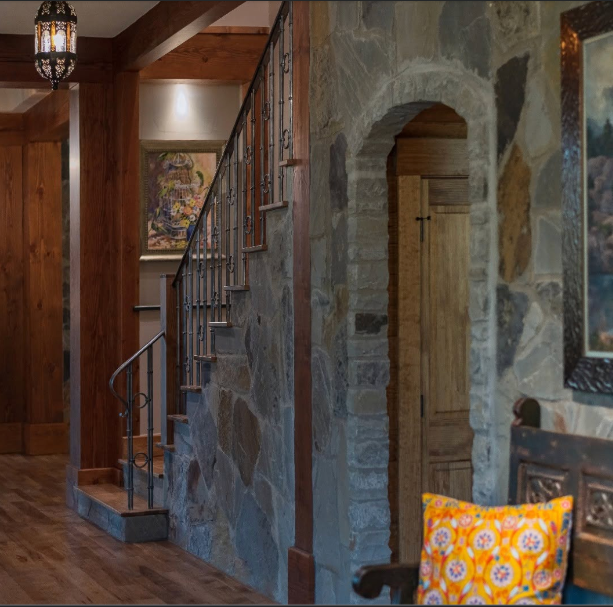 Stone stair wall with custom iron railing and lantern