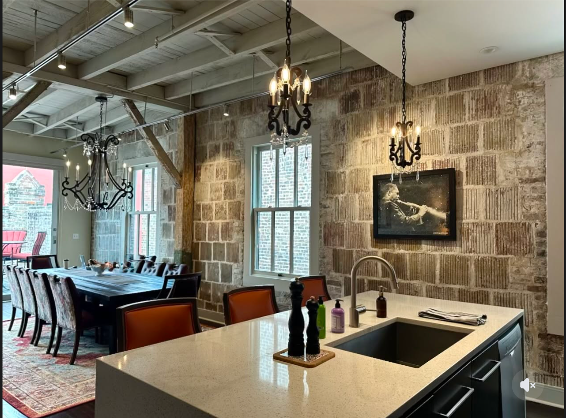 Custom iron chandeliers in the completed dining and kitchen space
